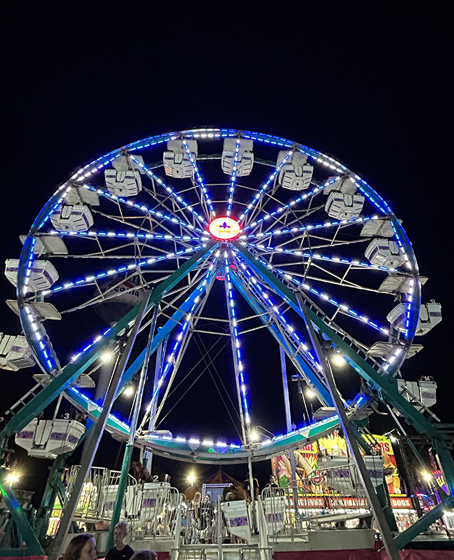 Carver County Fair Midway at night with Ferris Wheel in background