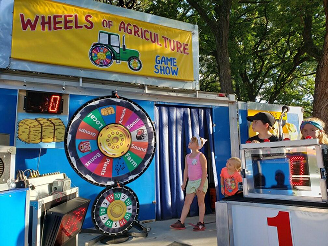 Kids playing Wheels of Agriculture game show watch the wheel spin