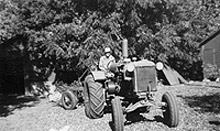 historical black and white photo of a man on a tractor