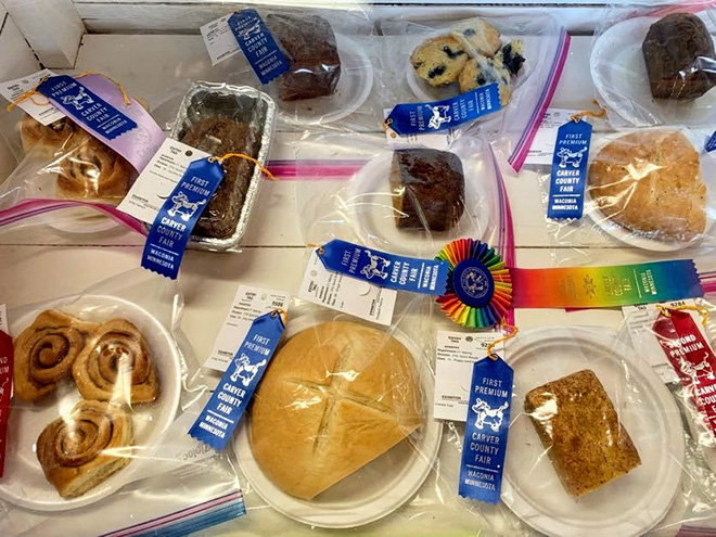 an assortment of baked goods with ribbons at the Carver County Fair