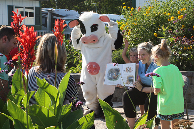 Tippy the cow acts out a story during Story Time with Tippy